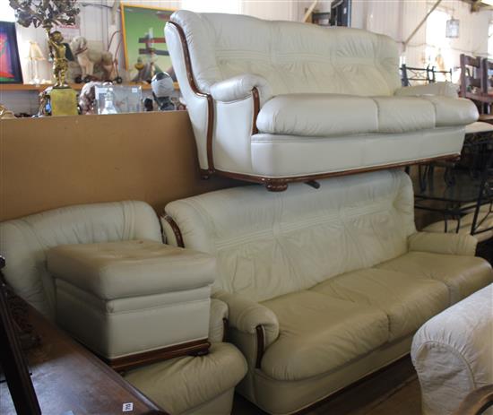 White leather upholstered lounge suite .pair of three seater settees,  armchair and a stool